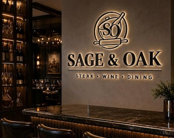 May include: A wall-mounted sign with backlit lettering reading SAGE & OAK STEAK WINE DINING, featuring a circular logo with the letters SO, a cooking pot, and a rolling pin, positioned above a dark marble bar counter with leather chairs.