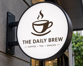 May include: A circular, wall-mounted sign with a black frame and a white face. The sign features a dark brown graphic of a steaming coffee cup above the text THE DAILY BREW, followed by the words COFFEE • TEA • SNACKS in smaller font.