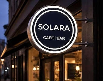 May include: A circular, illuminated sign mounted on a building exterior features a black background with white concentric rings. The text SOLARA is printed in white, followed by the text CAFE | BAR in a smaller white font below it.