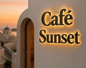 May include: A wall-mounted sign with the black text Café Sunset, featuring a warm golden backlight that illuminates the letters against a textured off-white wall, positioned next to an arched doorway overlooking a coastal sunset scene.