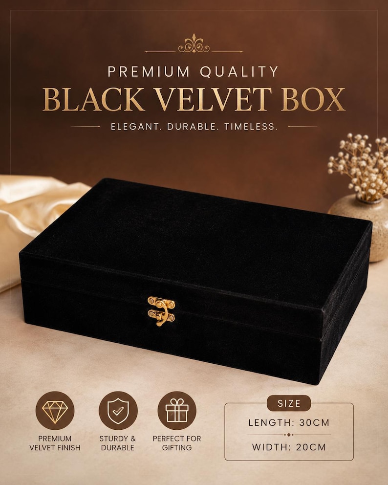 May include: A rectangular black velvet box featuring a gold-colored metal latch on the front. The text on the image reads PREMIUM QUALITY BLACK VELVET BOX, ELEGANT. DURABLE. TIMELESS. The box measures 30 cm in length and 20 cm in width.