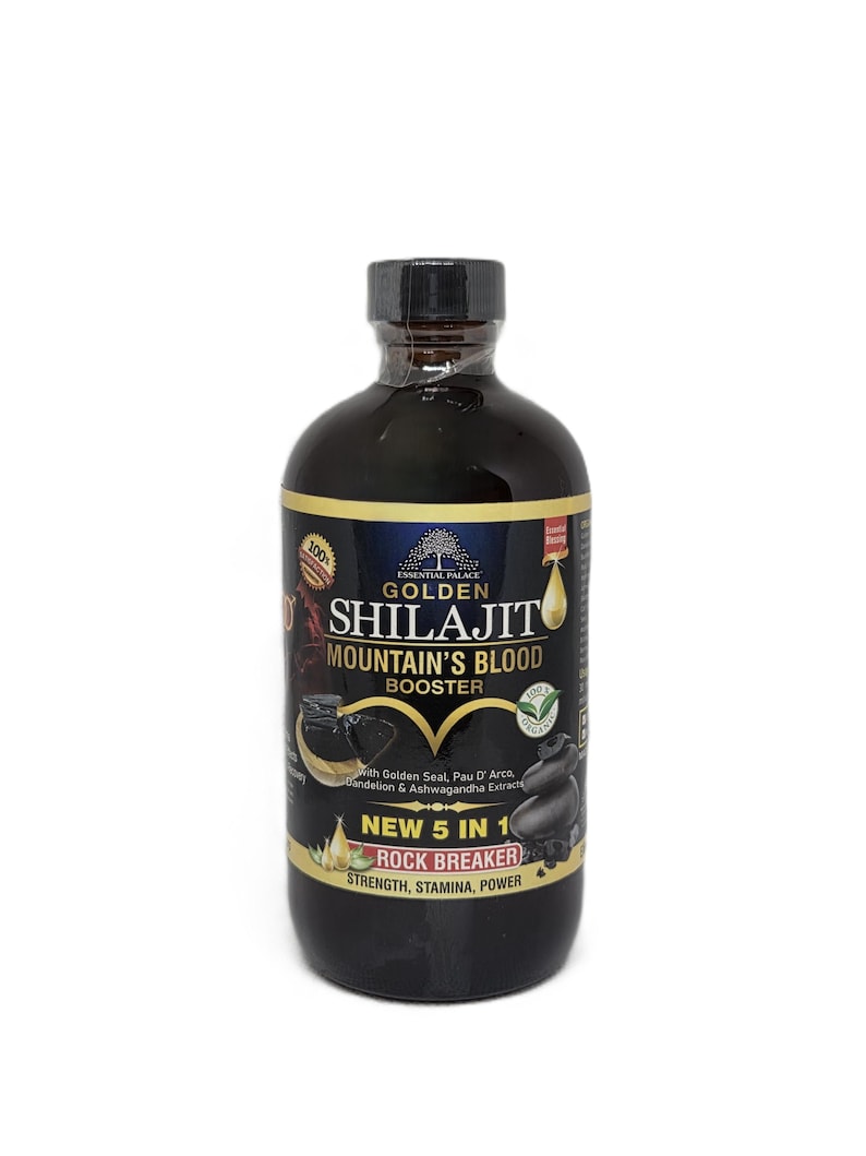 Puede incluir: Una botella marr&oacute;n oscuro de Golden Shilajit Mountain's Blood Booster. La etiqueta incluye el texto "NEW 5 IN 1 ROCK BREAKER" y "STRENGTH, STAMINA, POWER". La botella tiene una tapa negra y est&aacute; sobre un fondo blanco.