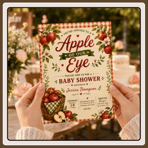 May include: A rectangular baby shower invitation card with a red and white gingham border. The text reads: You're invited to a Apple of our Eye, please join us for a baby shower honoring Jessica Thompson, Saturday October 18, 2:00pm.