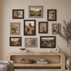May include: A gallery wall arrangement featuring nine framed prints with various landscape and floral scenes. The frames are in shades of brown, gray, and black. A wooden console table with decor sits below the framed art.