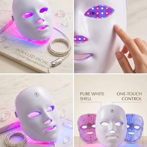 May include: A white LED facial mask with a sleek design. The mask features openings for the eyes, nose, and mouth, and is illuminated with colorful LED lights. The text "AURA LED FACIAL - 7-Color Rejuvenation -" is visible. The mask has a cord with a control.
