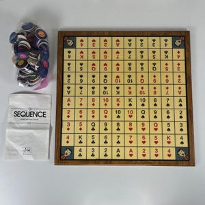 May include: A Sequence board game set featuring a square game board with a grid of playing card symbols and numbers, a plastic bag filled with multi-colored round playing chips, and a white paper instruction manual labeled with the text SEQUENCE.