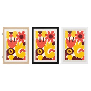 May include: Three framed wall art prints featuring a vibrant abstract pattern of red, yellow, and dark brown organic shapes, including stylised flowers and eye-like motifs. The set includes one light wood frame, one black frame, and one white frame.