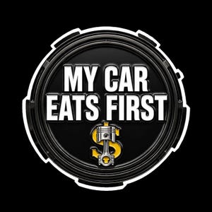 May include: A circular black emblem featuring the white text MY CAR EATS FIRST in bold capital letters. Centered below the text is a silver engine piston graphic superimposed over a yellow dollar sign symbol, all enclosed by a thick white border.
