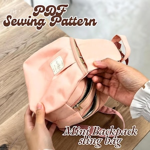 May include: A peach-colored mini backpack sling bag featuring multiple zippered compartments with gold-tone hardware and a small rectangular label on the front. The text PDF Sewing Pattern and Mini Backpack sling bag is visible.