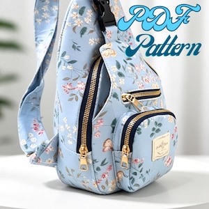 May include: A light blue sling backpack featuring a floral pattern with small pink and white flowers and green leaves. The bag has gold-tone zips, a dark blue trim, and a rectangular label. The text PDF Pattern is visible in the upper right.