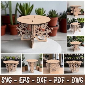 May include: A light-colored wooden plant stand featuring a circular top and intricate laser-cut floral or butterfly-shaped side panels. This decorative display piece is designed for tabletop use and is shown in various styles including flower, butterfly, and leaf motifs.
