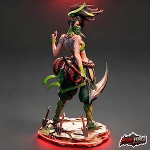 May include: A detailed figurine of a warrior with dark hair, wearing a green mask and outfit, featuring a large back tattoo, holding a curved blade, and standing on a rocky base with three small daggers. The AkariForge logo is in the corner.