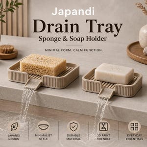 May include: Two beige rectangular drain trays with ribbed surfaces and integrated spouts, one holding a tan sponge and the other a white soap bar. Text reads Japandi Drain Tray Sponge & Soap Holder, Minimal Form. Calm Function. 2 sizes: 115 x 65 mm and 142 x 76 mm.