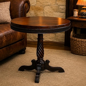 May include: A round wooden side table with a dark brown finish, featuring a smooth circular top, a decorative carved rope-patterned edge, a central spiraled pedestal column, and a sturdy four-legged base with curved feet for stability.