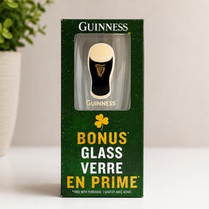 May include: A Guinness branded glass in a green box. The box features the Guinness logo and the words "BONUS GLASS VERRE EN PRIME". The glass is black with a white top and a harp logo.