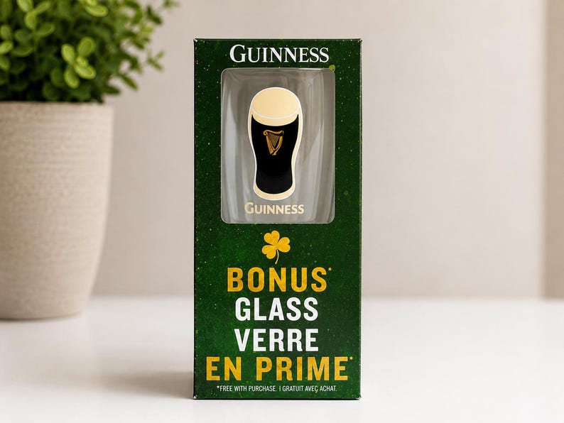 May include: A Guinness branded glass in a green box. The box features the Guinness logo and the words "BONUS GLASS VERRE EN PRIME". The glass is black with a white top and a harp logo.