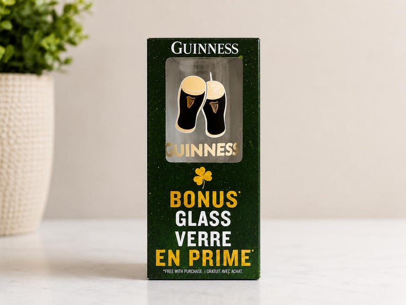 May include: A dark green box with the Guinness logo and a clear window displaying a pint glass. The box also features the words "BONUS GLASS VERRE EN PRIME" in yellow.