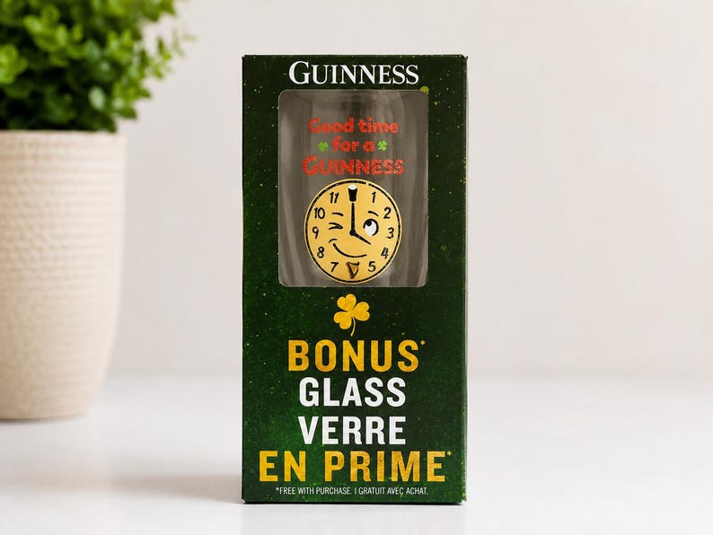 May include: A Guinness glass in a green box. The glass has a clock face design with the text "Good time for a Guinness." The box also says "BONUS GLASS VERRE EN PRIME."