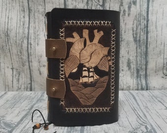 Leather and wood adventure tome hollow book dice box with sea serpent loch ness carving on cover