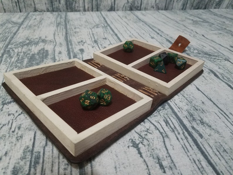 Leather and wood adventure tome hollow book dice box with sea serpent loch ness carving on cover