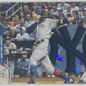 May include: Baseball card featuring Aaron Judge of the New York Yankees in action during the All-Star Game. The card has a close-up of the Yankees logo and the Topps logo. The player is wearing a gray uniform with navy blue accents.