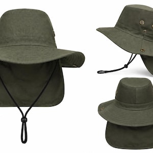 May include: An olive green sun hat featuring a wide brim, a detachable neck flap, and a black adjustable chin strap with a plastic toggle. The hat includes metal ventilation eyelets on the sides and snap buttons for securing the neck flap.
