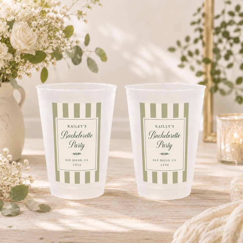May include: Two frosted plastic cups featuring a sage green and white vertical striped design. The center label reads Kailey's Bachelorette Party, San Diego, CA, 2026, with decorative flourishes. The cups have a smooth, translucent finish.