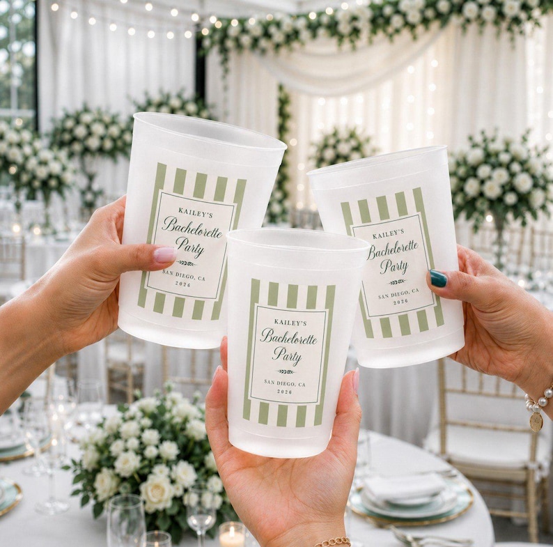 May include: Three frosted plastic cups held in hands, each featuring a sage green vertical striped border and a central white label with the text Kailey's Bachelorette Party, San Diego, CA, 2026, printed in a dark green script and serif font.