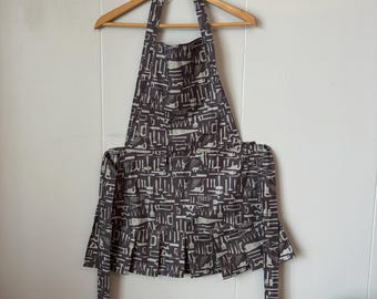 Retro-inspired brown tools apron with wide pleated hem