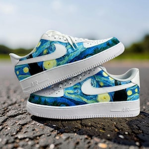 May include: Two white and blue sneakers with a design inspired by Van Gogh's "Starry Night" painting. The shoes have white soles, laces, and Nike swooshes. The uppers feature the swirling blue, yellow, and green colors of the famous artwork.