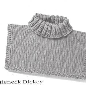 May include: A grey knitted turtleneck dickey featuring a ribbed collar and a rectangular chest panel with a stockinette stitch pattern and a garter stitch border. The text "Turtleneck Dickey" is printed in dark grey at the bottom left corner.