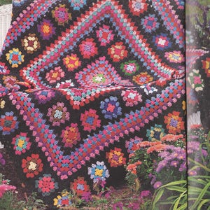 May include: A handmade crochet blanket featuring a black base with a repeating granny square pattern. The squares are composed of vibrant, multi-colored yarn in shades of pink, red, yellow, blue, purple, and orange, creating a bold contrast.
