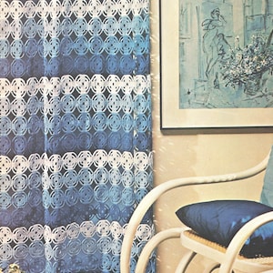 May include: A floor-length curtain featuring a repeating circular crochet pattern in shades of dark blue, light blue, and white. The fabric has a semi-sheer, open-weave construction with horizontal bands of varying blue tones and white circular motifs.