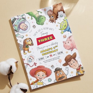May include: A rectangular birthday invitation card featuring colorful cartoon illustrations of various toy characters. The text reads: You've got a friend who's turning three. Please join us in celebrating Adam's 3rd birthday, Saturday, Nov 14, 2026, 2:00 PM.