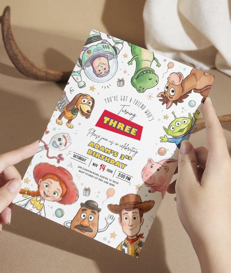 May include: A rectangular birthday invitation card featuring colorful cartoon illustrations of various toy characters. The text reads: You've got a friend who's turning THREE, Please join us in celebrating ADAM'S 3RD BIRTHDAY, SATURDAY NOV 14 2026 2:00 PM.