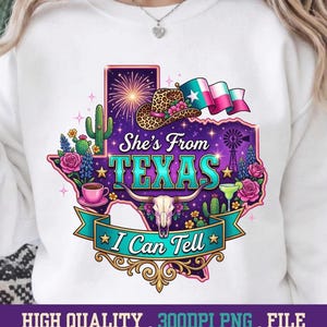 May include: White sweatshirt with a colorful graphic of the state of Texas. The design includes a cowboy hat, flowers, a windmill, and the text "She's From Texas I Can Tell".