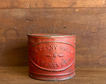 1900s “A Penny Saved” Embossed Tin Coin Bank – Early Folk Art Savings Storage Box in Original Red Paint.