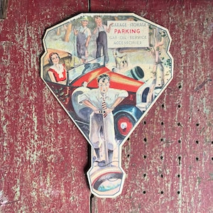May include: A vintage paper fan advertising garage storage, parking, gas, oil service, and accessories. The fan features a colorful illustration of a car, people, and a dog.