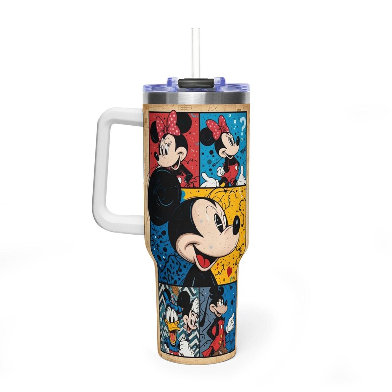 May include: A large tumbler with a white handle and a straw. The tumbler has a colourful pop art design featuring Mickey and Minnie Mouse, plus other Disney characters. The background is a mix of blue, red, and yellow.