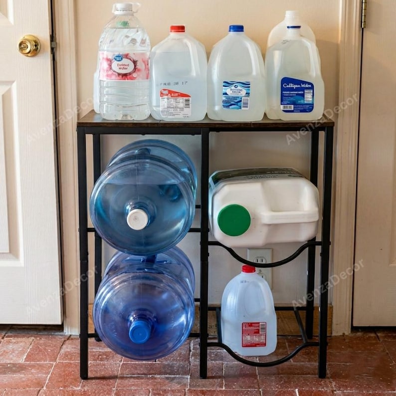 May include: A black metal storage rack holding multiple water containers. The top shelf features four gallon jugs, while the bottom section holds two large blue five-gallon water jugs on the left and a white jug with a green cap on the right.