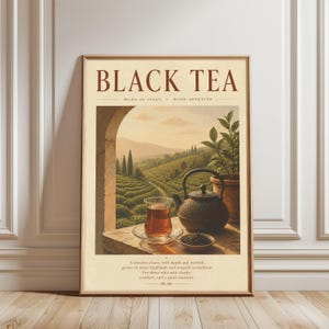 May include: A rectangular wall art print featuring the text BLACK TEA, MADE IN ITALY, BUON APPETITO. The illustration shows a glass of tea, a dark teapot, and a potted plant on a stone ledge overlooking a landscape of rolling hills and trees.