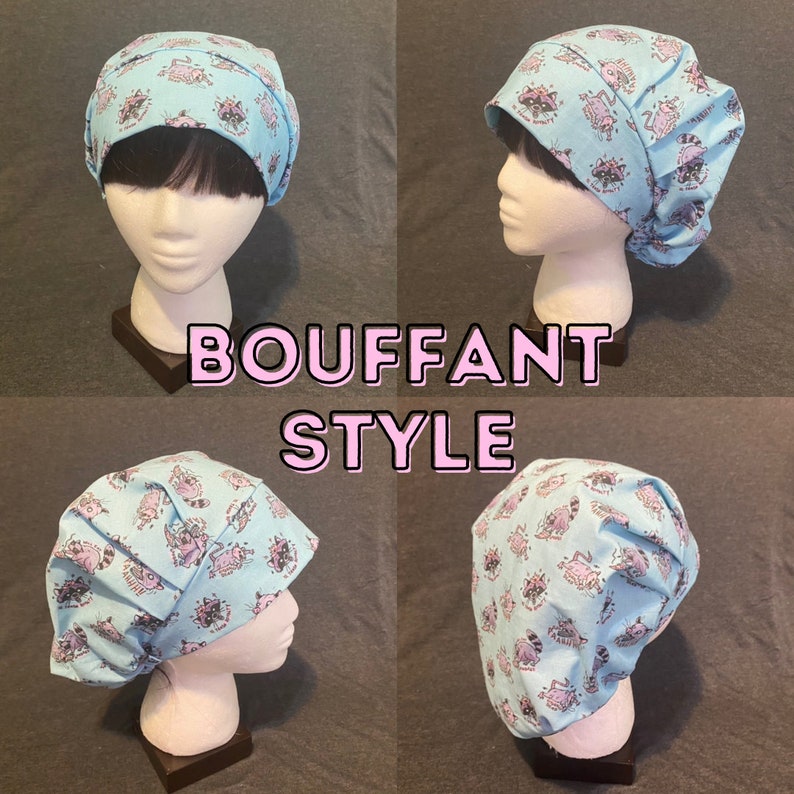 May include: A light blue surgical scrub hat with a pink and white raccoon print. The hat is styled in a bouffant style, with the fabric gathered at the top. The text "BOUFFANT STYLE" is printed in pink letters on a white background.