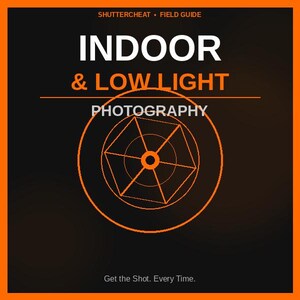 May include: An orange-bordered graphic with the text "INDOOR & LOW LIGHT PHOTOGRAPHY." The image includes a geometric design and the phrase "Get the Shot. Every Time." The top of the image reads "SHUTTERCHEAT • FIELD GUIDE."