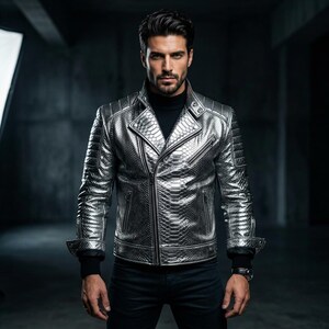 May include: A silver snakeskin-effect biker jacket with a notched collar and an asymmetrical zip. The jacket has quilted shoulder detailing and is worn with a black turtleneck and black trousers. The jacket is a fitted style.