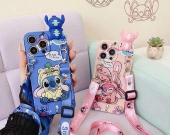 May include: Two phone cases featuring the character Stitch. One is blue with a Stitch design wearing a bear hat, and the other is pink with a Stitch design wearing a bunny hat. Both cases have matching lanyards.