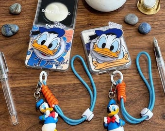 Magnetische standaard Leuke Donald Duck-telefoonhoes voor Samsung Galaxy Z Flip 7 6 5 4 3, doorzichtige cartoonhoes met 3D-charme lanyardriem
