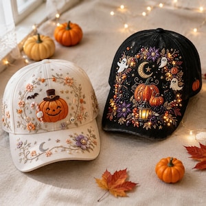 May include: A cream-colored baseball cap featuring embroidered pumpkins, flowers, and a bat, alongside a black baseball cap adorned with embroidered pumpkins, ghosts, a crescent moon, and a lantern, both decorated with small beads and sequins.