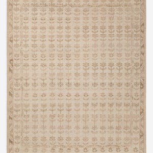 May include: Beige rectangular area rug with a floral pattern. The rug features a repeating design of stylized flowers in varying shades of brown. A border with geometric and floral motifs frames the central pattern. The rug is made of a woven material.