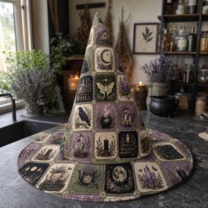 May include: A pointed hat featuring a grid pattern of square panels. Each panel displays illustrations of celestial bodies, moths, ravens, cauldrons, candles, crystals, and floral arrangements in shades of purple, green, black, and cream.