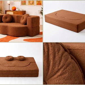 May include: A brown, textured, modular sofa that converts into a flat floor mattress. The piece features a soft, fuzzy fabric finish, rounded edges, and two matching circular throw pillows. It can be configured as a structured seat or a bed.